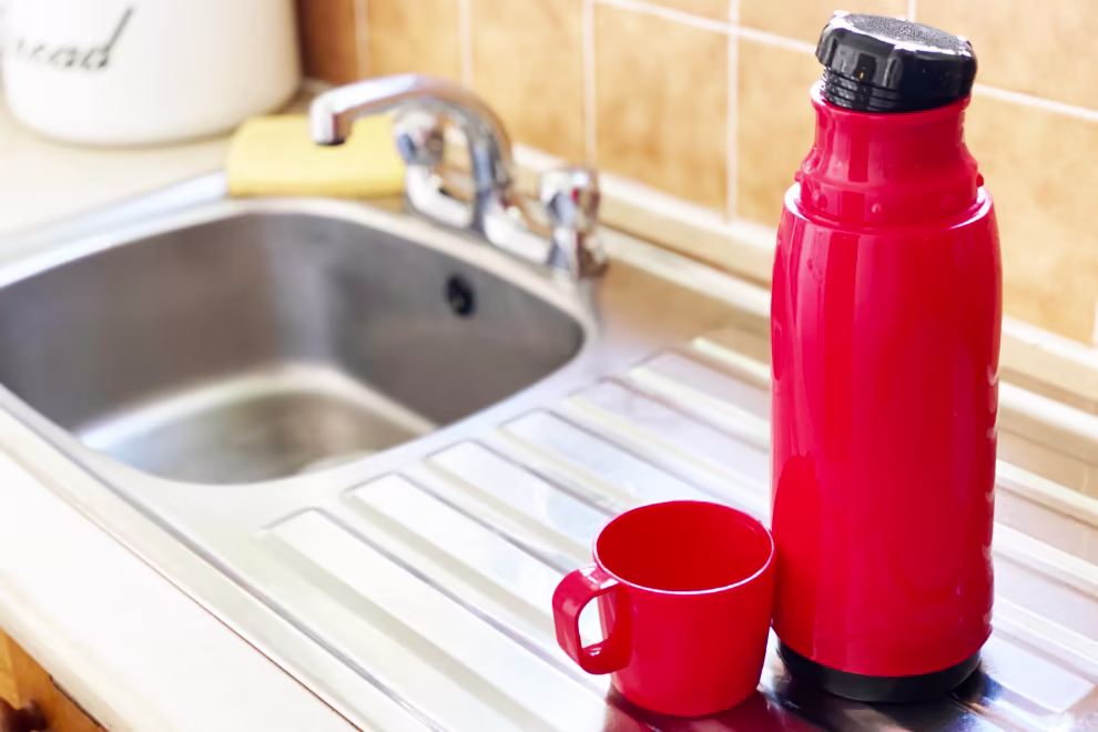 a-flask-beside-a-kitchen-sink.avif