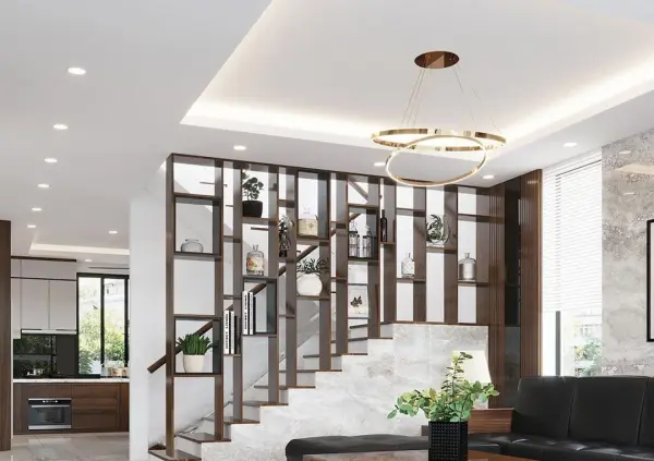 Không gian phòng khách hiện đại với cầu thang, kệ sách, đèn trần và bếp tích hợp.