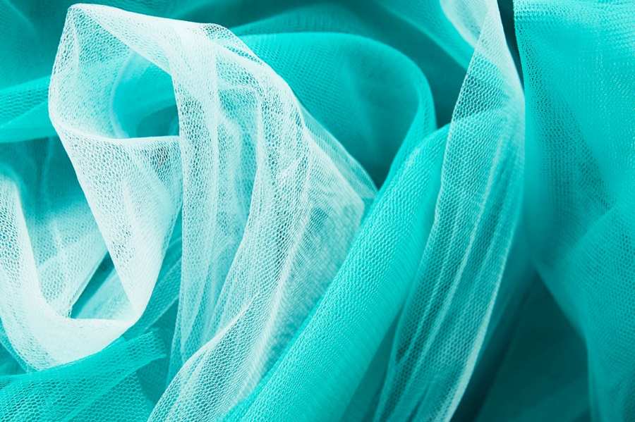 Close-up of turquoise tulle fabric.